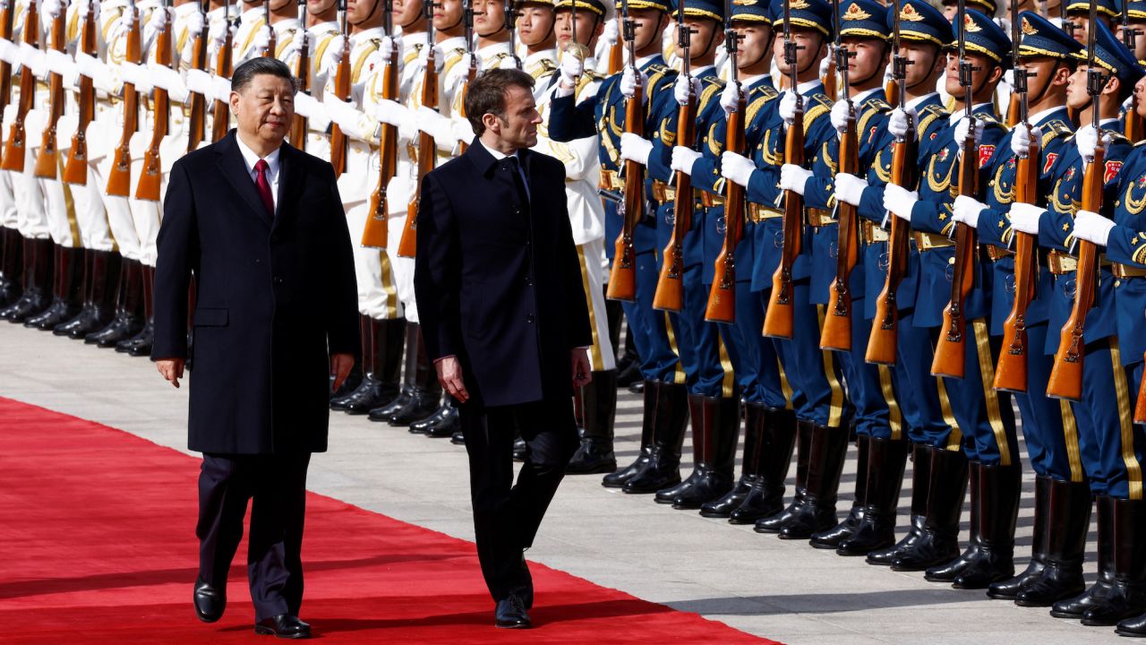 Chinese President Xi Jinping and French President Emmanuel Macron review troops during an official ceremony at the Great Hall of the People, in Beijing, China, April 6, 2023.