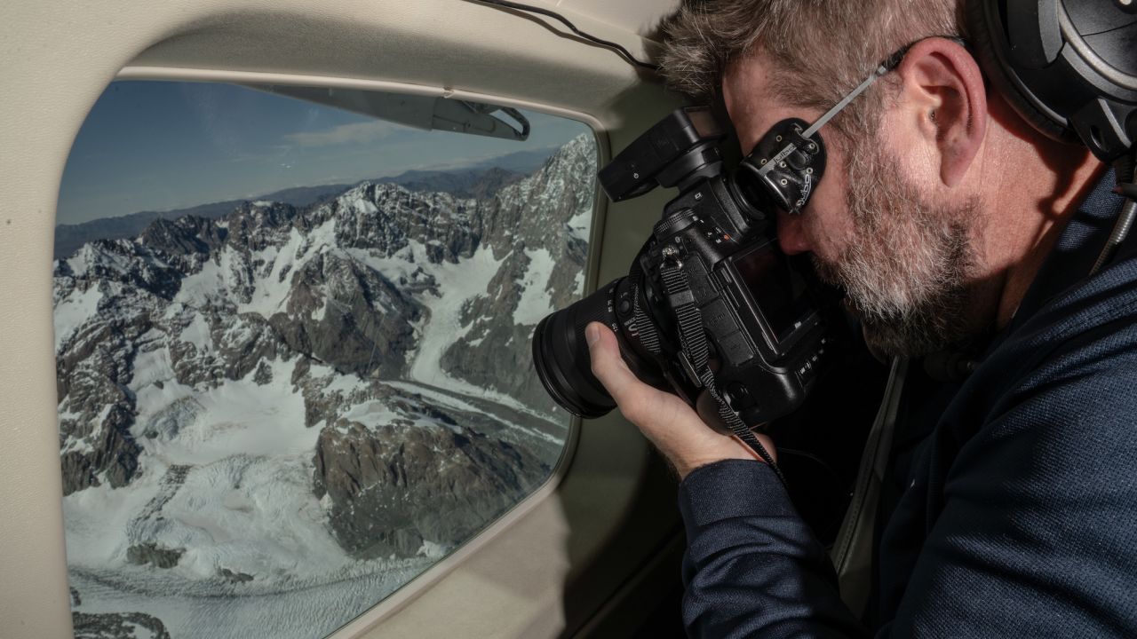 Principal scientist Andrew Lorrey takes photos of Tasman Glacier during the flight.