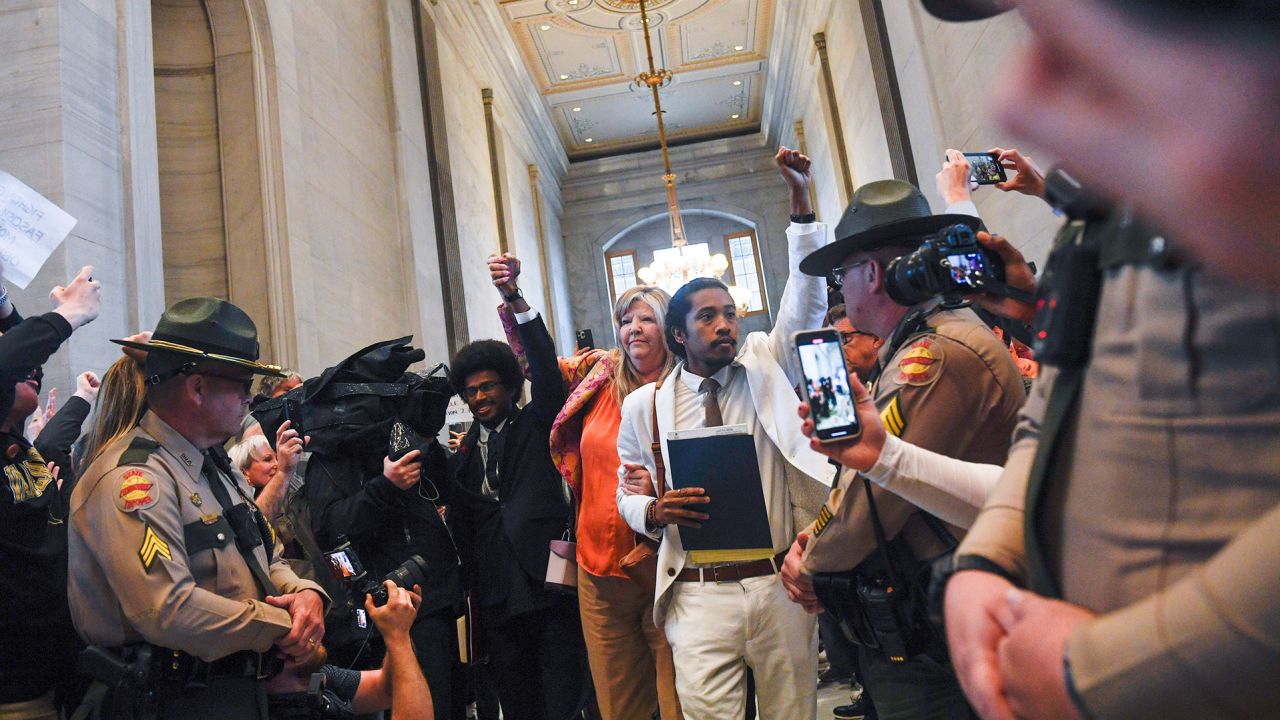 Reps. Justin Pearson, Gloria Johnson and Justin Jones walk through a crowd of supporters at the Tennessee state Capitol in Nashville on Thursday.