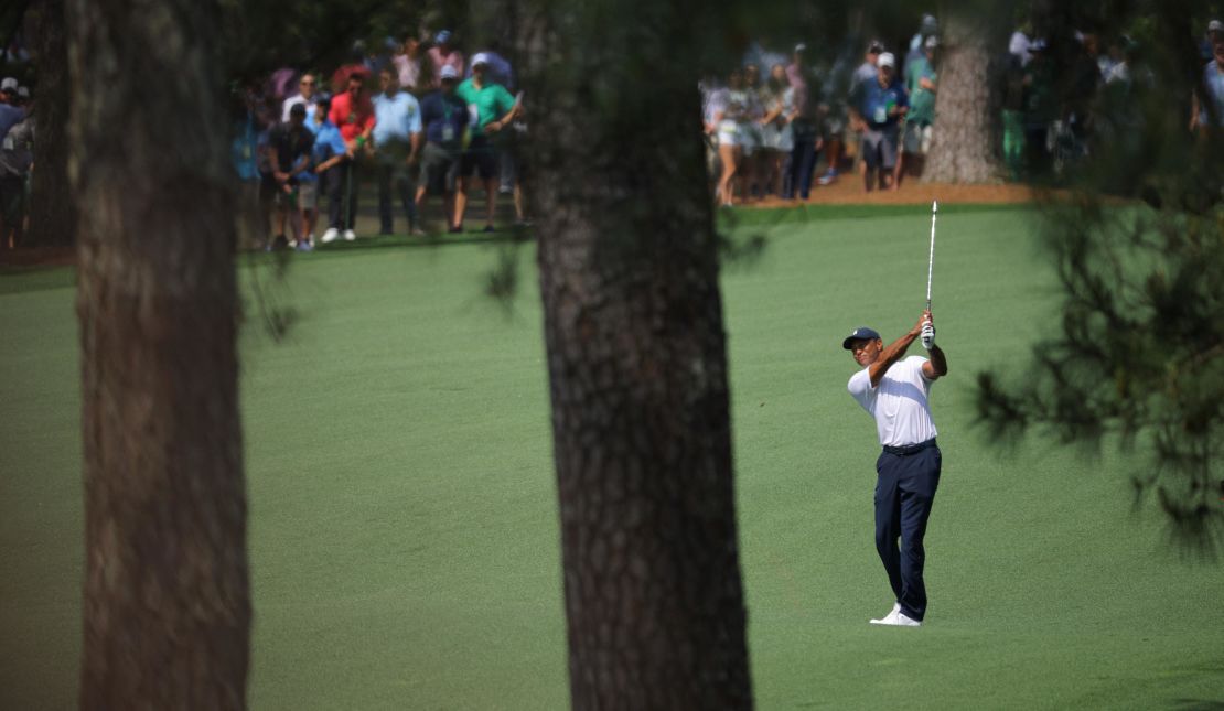 Woods hits his approach on the 7th hole.