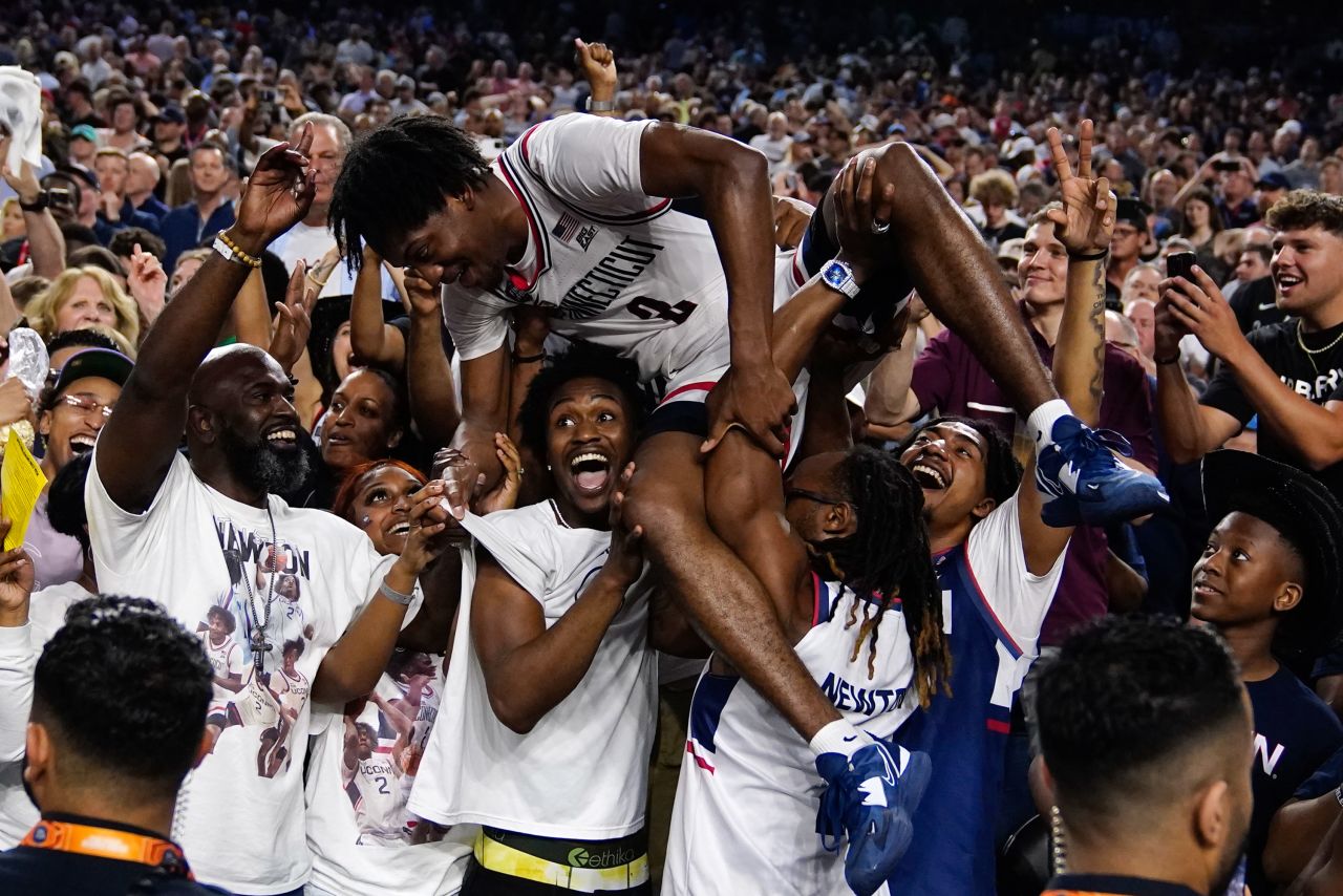 UConn basketball player Tristen Newton is lifted in the postgame celebrations after the Huskies won the NCAA Tournament final on Monday, April 3. They defeated San Diego State 76-59 to win the fifth national title in school history.