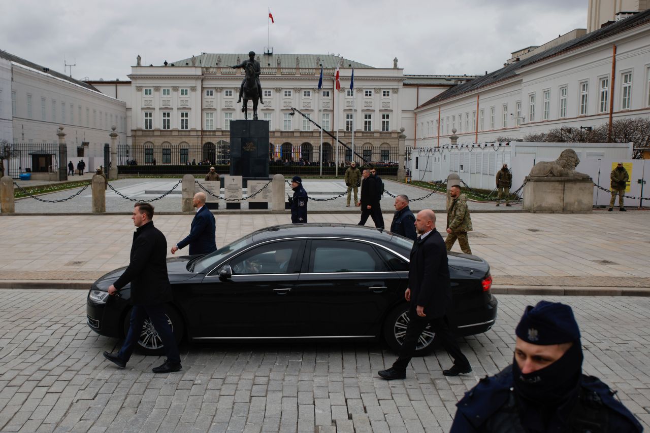 A car carrying Ukrainian President Volodymyr Zelensky and first lady Olena Zelenska arrives at the Presidential Palace in Warsaw, Poland, on Wednesday, April 5. It was Zelensky's first formal visit to the country since Russia invaded Ukraine last year.