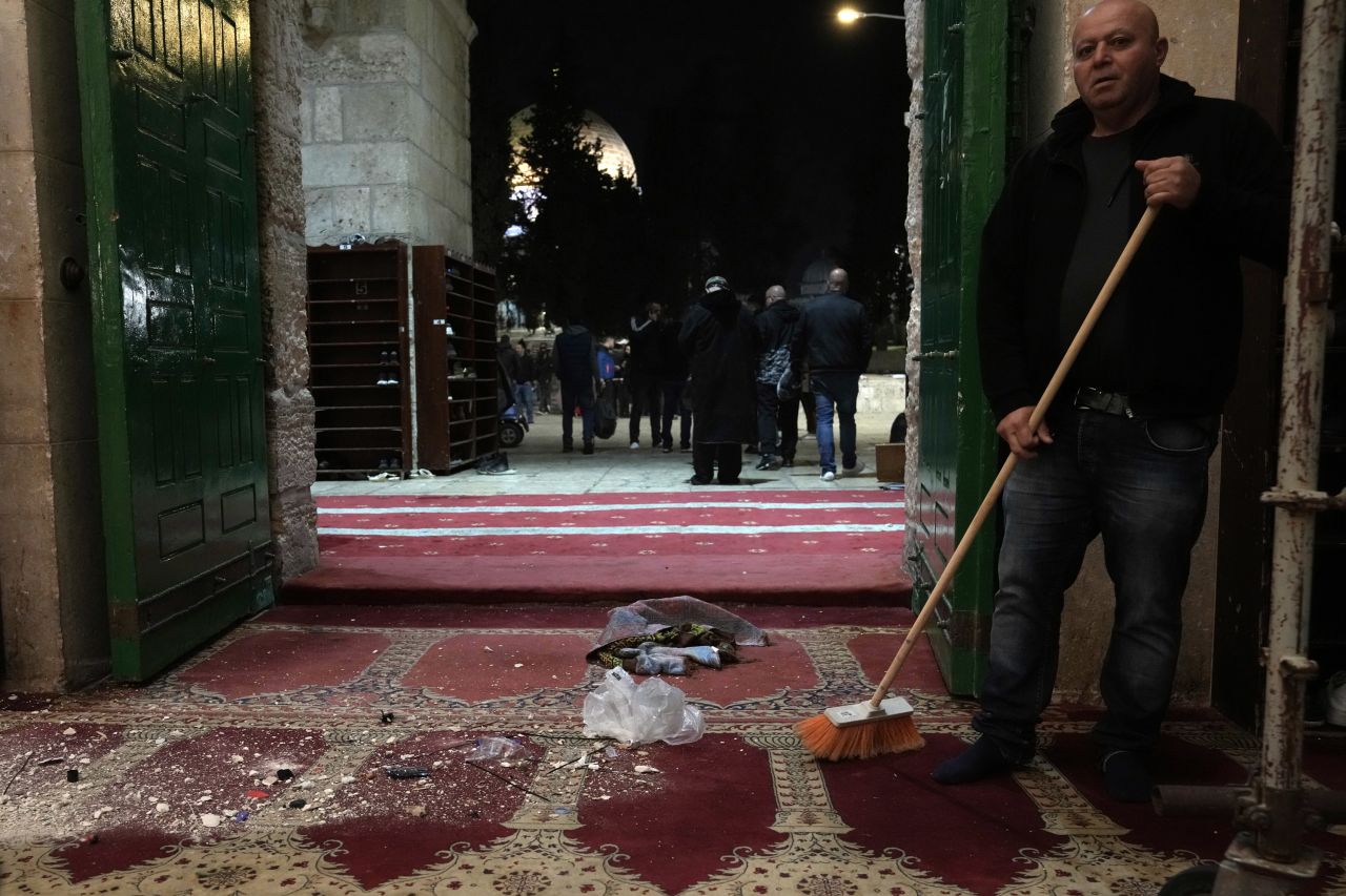 A man sweeps debris Wednesday, April 5, after an Israeli police raid at the al- Aqsa mosque in Jerusalem. Police stormed the mosque on two separate occasions Wednesday as Palestinian worshippers offered prayers during the holy month of Ramadan. Police said they entered the mosque and made more than 350 arrests after 