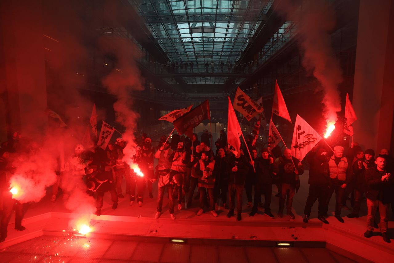 Demonstrators force their way into the building that houses BlackRock's office in Paris on Thursday, April 6. They were taking their protest against the government's pension reforms to the world's biggest money manager. About 100 people, including representatives of several labor unions, were on the ground floor of the building for about 10 minutes, chanting anti-reform slogans.