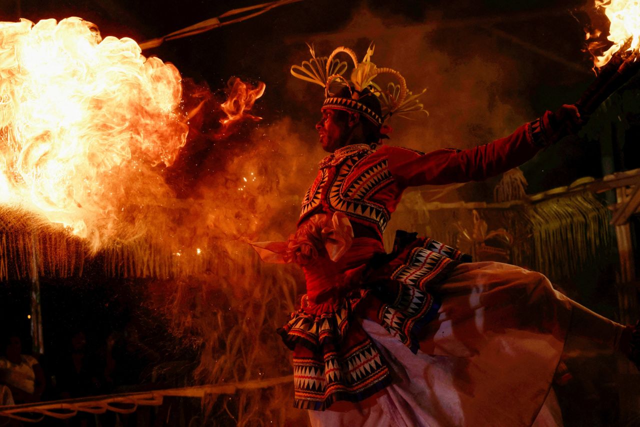 A dancer performs with fire during a Gammaduwa performance at a Buddhist temple in Colombo, Sri Lanka, on Friday, March 31.  