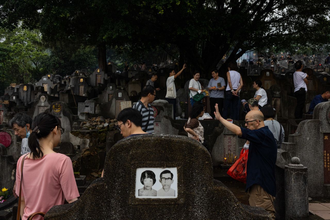 People honor their ancestors at a cemetery in Hong Kong on Wednesday, April 5. During the Qingming Festival, also known as Tomb Sweeping Day, people visit their ancestors' graves to clean up and burn offerings.