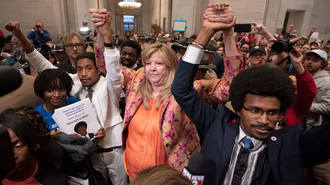 Justin Jones, Gloria Johnson and Justin Pearson raise their hands outside the state House chamber after Jones and Pearson were expelled from the legislature on Thursday, April 6, 2023, in Nashville.