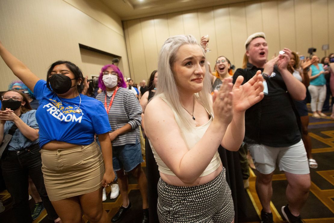 Allie Utley, center, holds back tears after hearing that voters rejected a proposed amendment to the Kansas Constitution, which would have allowed lawmakers to ban abortion in the state, at the Overland Park Convention Center on Tuesday, August 2, 2022. 