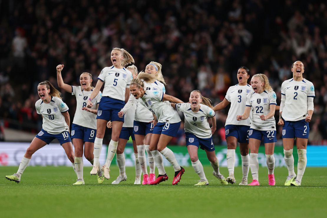 England's players celebrate winning the penalty shootout against Brazil.