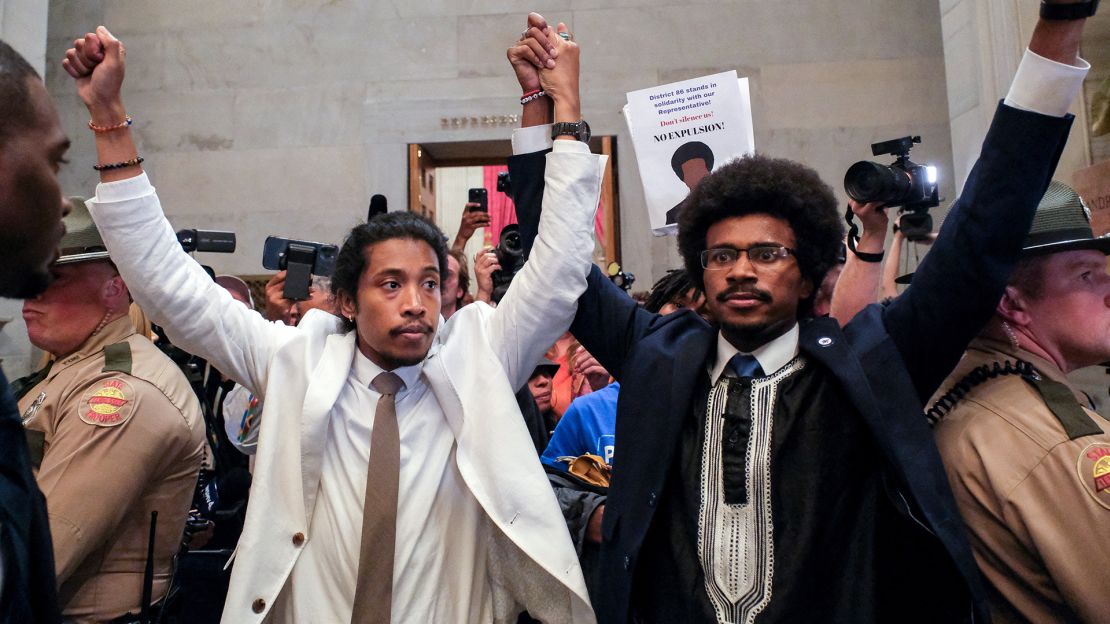 Justin Pearson and Justin Jones raise their hands after being expelled from their seats in the Tennessee House in Nashville Thursday.