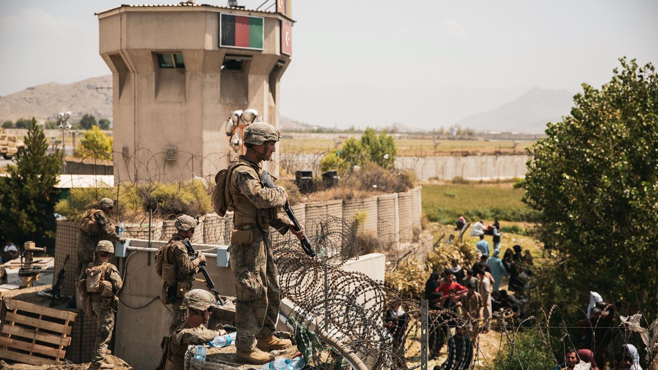 In this photo from the US Central Command Public Affairs office, US Marines assist with security at an evacuation control checkpoint during an evacuation at Hamid Karzai International Airport in Kabul, Afghanistan, on August 20, 2021.
