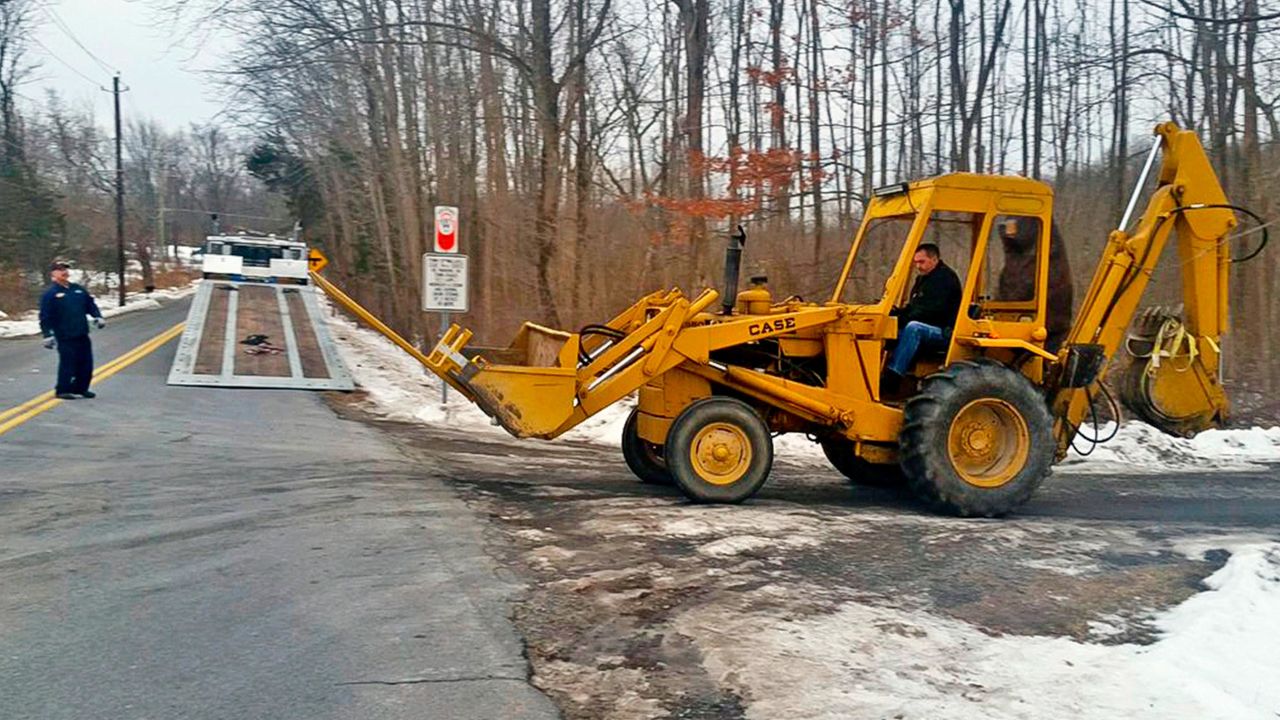 FBI investigators remove a backhoe seized from the Crawford, N.Y., property of former Briarcliff Manor Police officer Nicholas Tartaglione, Dec. 21, 2016.
