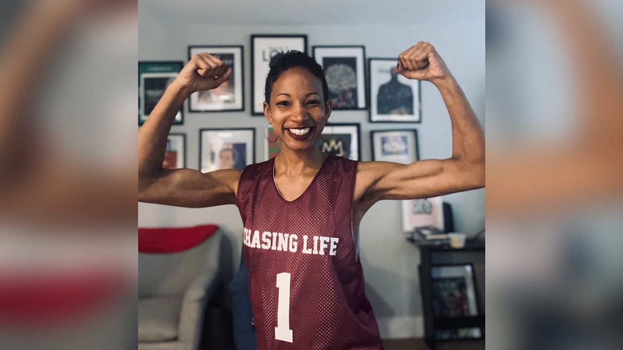 Eryn Mathewson wearing a jersey gifted by her CNN teammates. "Chasing Life" refers to CNN's health and wellness podcast, 'Chasing Life' with Dr. Sanjay Gupta.