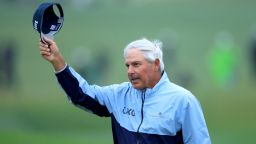 Fred Couples of The United States acknowledges the patrons as he walks off the 18th green having made the cut on one over par during the completion of the weather delayed second round of the 2023 Masters Tournament at Augusta National Golf Club on April 08, 2023 in Augusta, Georgia.