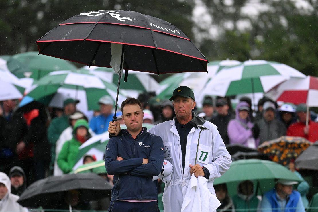 Justin Thomas of the United States and his caddie Jim 'Bones' Mackay react to his bogey on the 18th green  during the continuation of the weather delayed second round of the 2023 Masters Tournament at Augusta National Golf Club on April 08, 2023 in Augusta, Georgia.