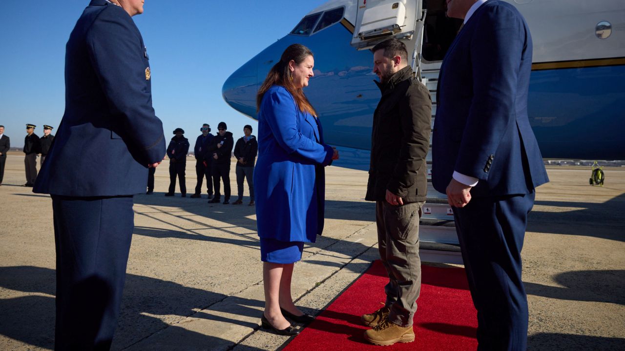 Ukrainian President Volodymyr Zelensky speaks with Oksana Markarova, the Ukrainian ambassador to the US, as he arrives in Washington, DC, on December 21, 2022.  