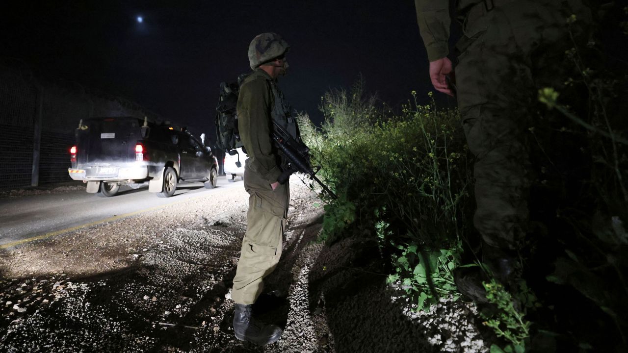 Israeli soldiers patrol during a search for a rocket that landed near Kibbutz Meitsar in the Golan Heights on April 9, 2023.