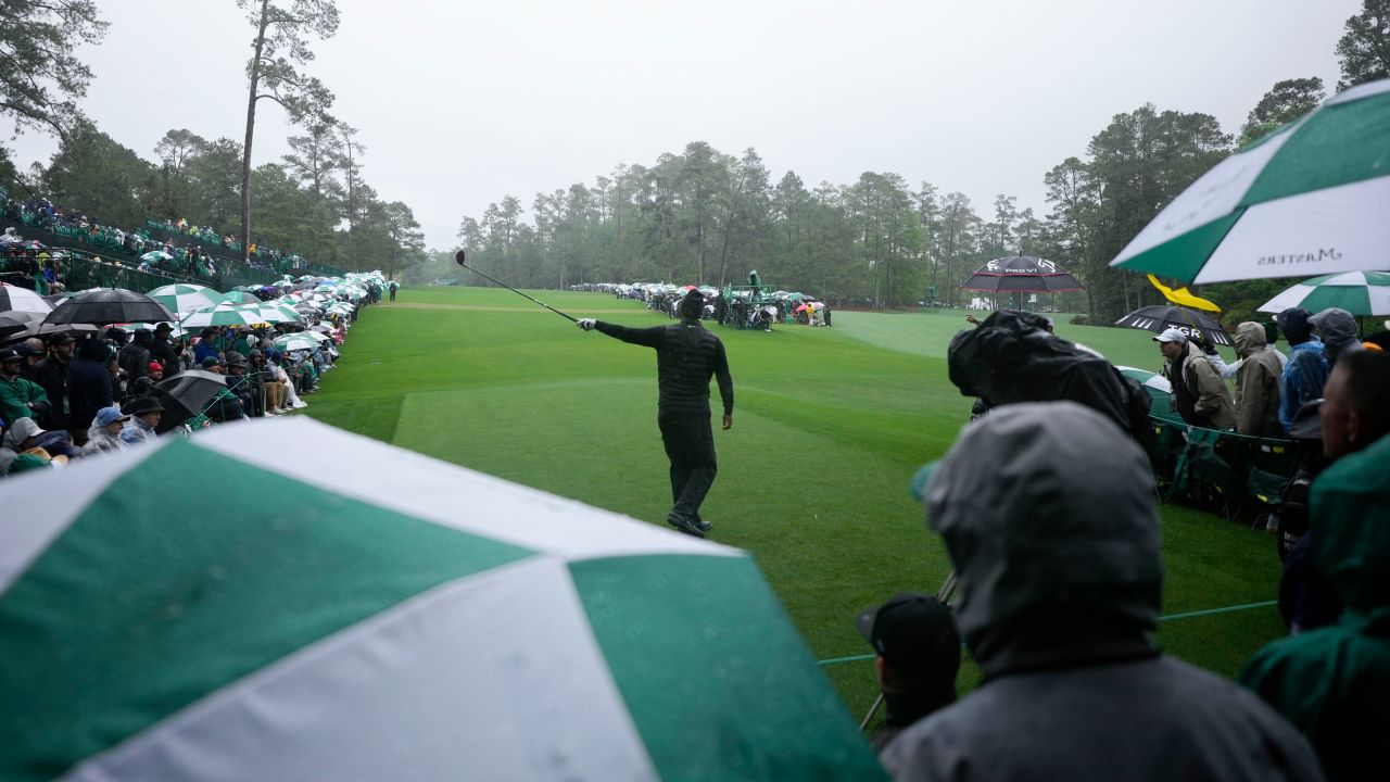 Woods points in the direction of his tee shot on the 14th hole during the third round. 