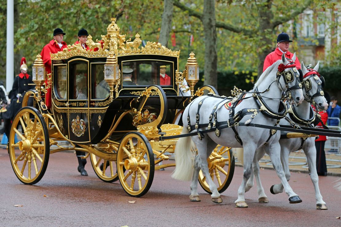 Britain's Queen Elizabeth II rides with then-Prince Charles and Camilla in the Diamond Jubilee State Coach in 2019 to the State Opening of Parliament. 
