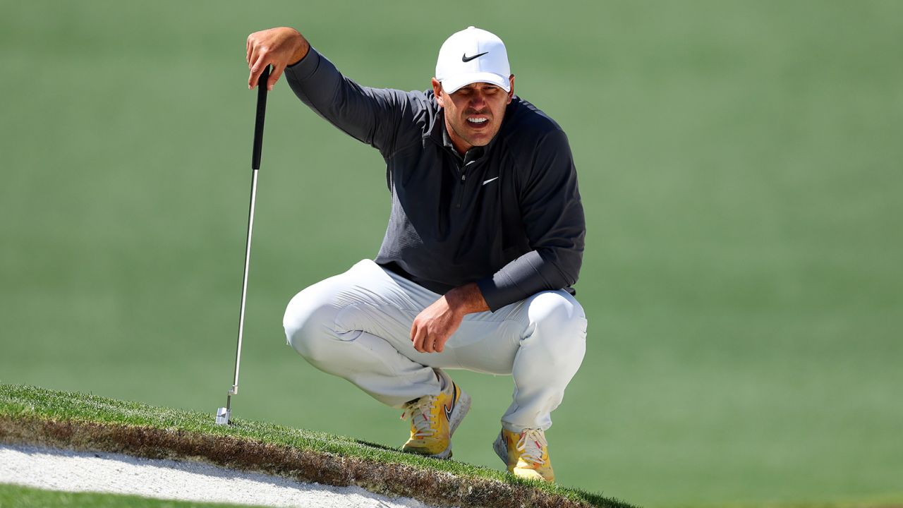 Koepka looks over a putt.