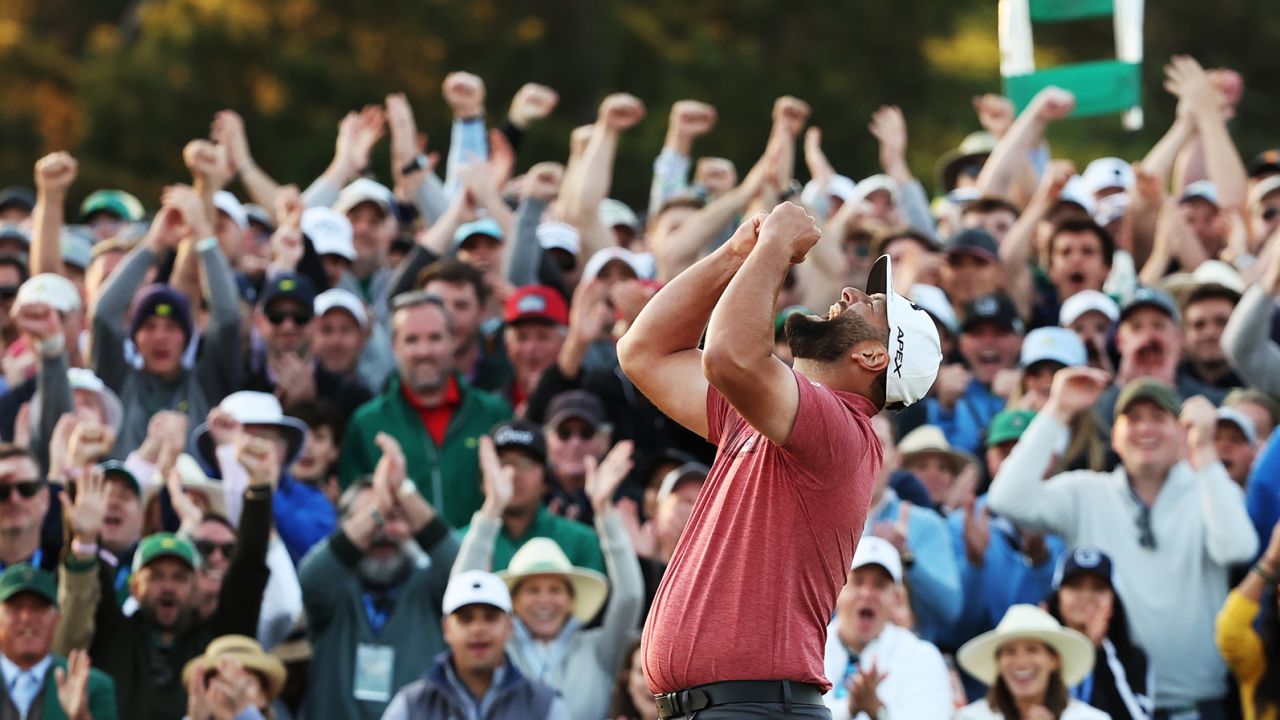 Rahm celebrates victory on the 18th green.