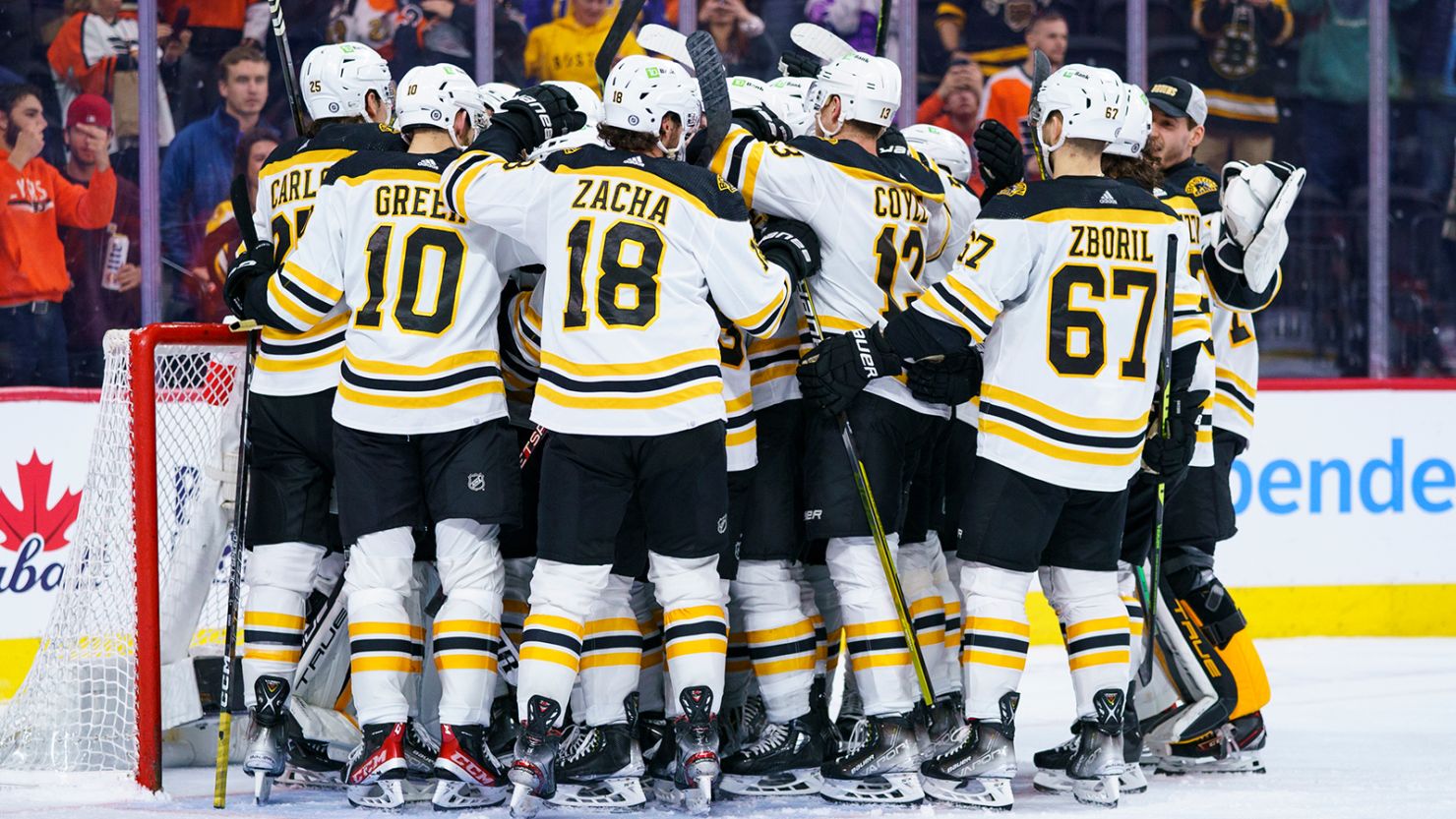 Boston Bruins gather around Jeremy Swayman as they celebrates their win against the Philadelphia Flyers on Sunday, April 9, 2023, in Philadelphia. 
