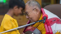 Tibetan spiritual leader the Dalai Lama touches foreheads with a young boy, who has been blurred by CNN to protect his identity, before addressing a group of students at the Tsuglakhang temple in Dharamshala, India, Tuesday, Feb. 28, 2023. (AP Photo/Ashwini Bhatia)