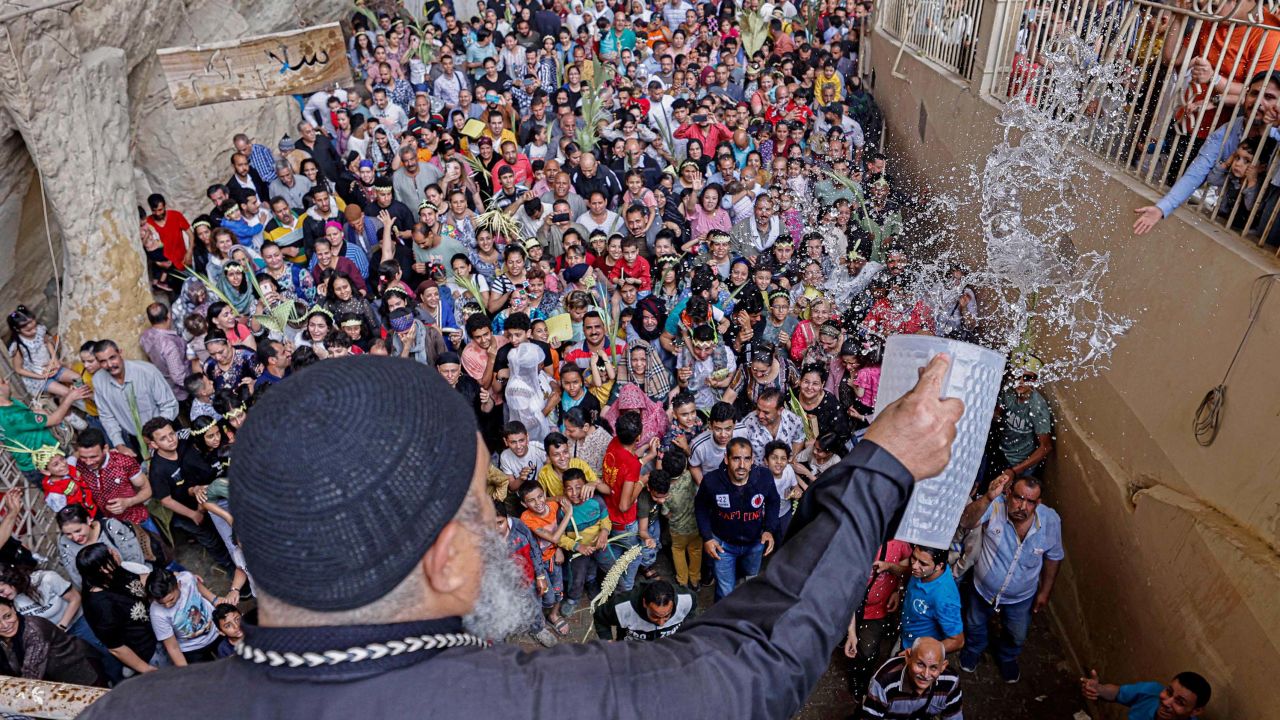 An Egyptian Coptic priest sprinkles holy water during Palm Sunday Mass at the Saint Simon Monastery, also known as the Cave Church, in Cairo's Mokattam mountain on Sunday.