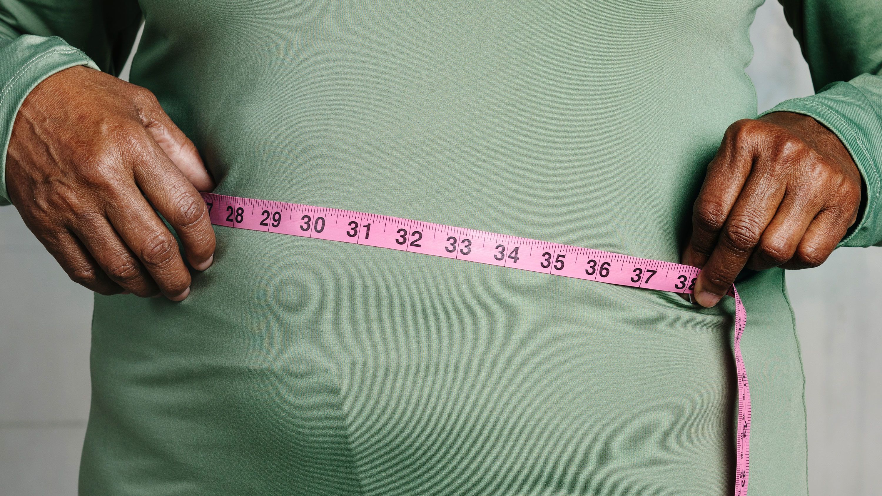 Mature Woman With Tape Measure Around Waist Mid Section High-Res Stock  Photo - Getty Images