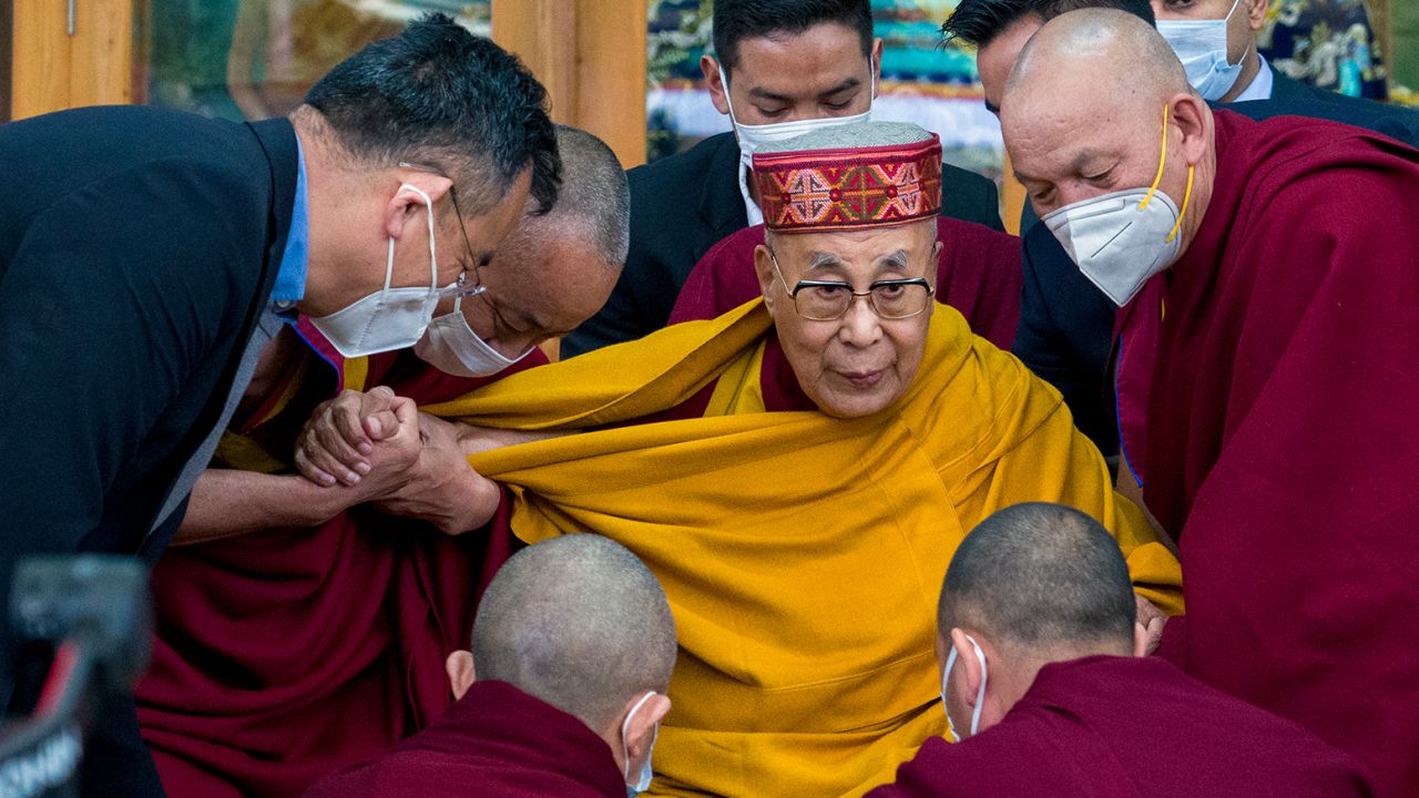 Tibetan spiritual leader the Dalai Lama is helped by attending monks after he addressed a group of students at the Tsuglakhang temple in Dharamshala, India, on February 28, 2023.