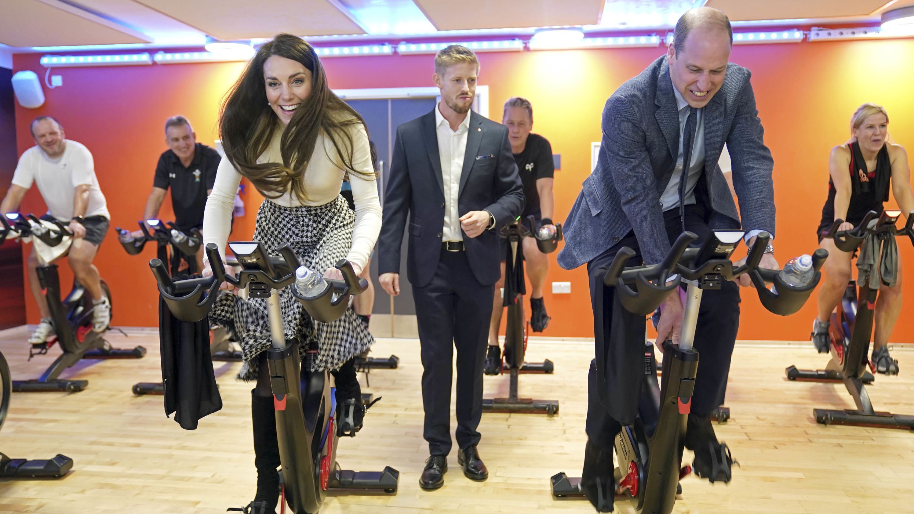 William and Catherine take part in a spin class during while visiting a fitness center in Port Talbot, Wales, in February 2023.