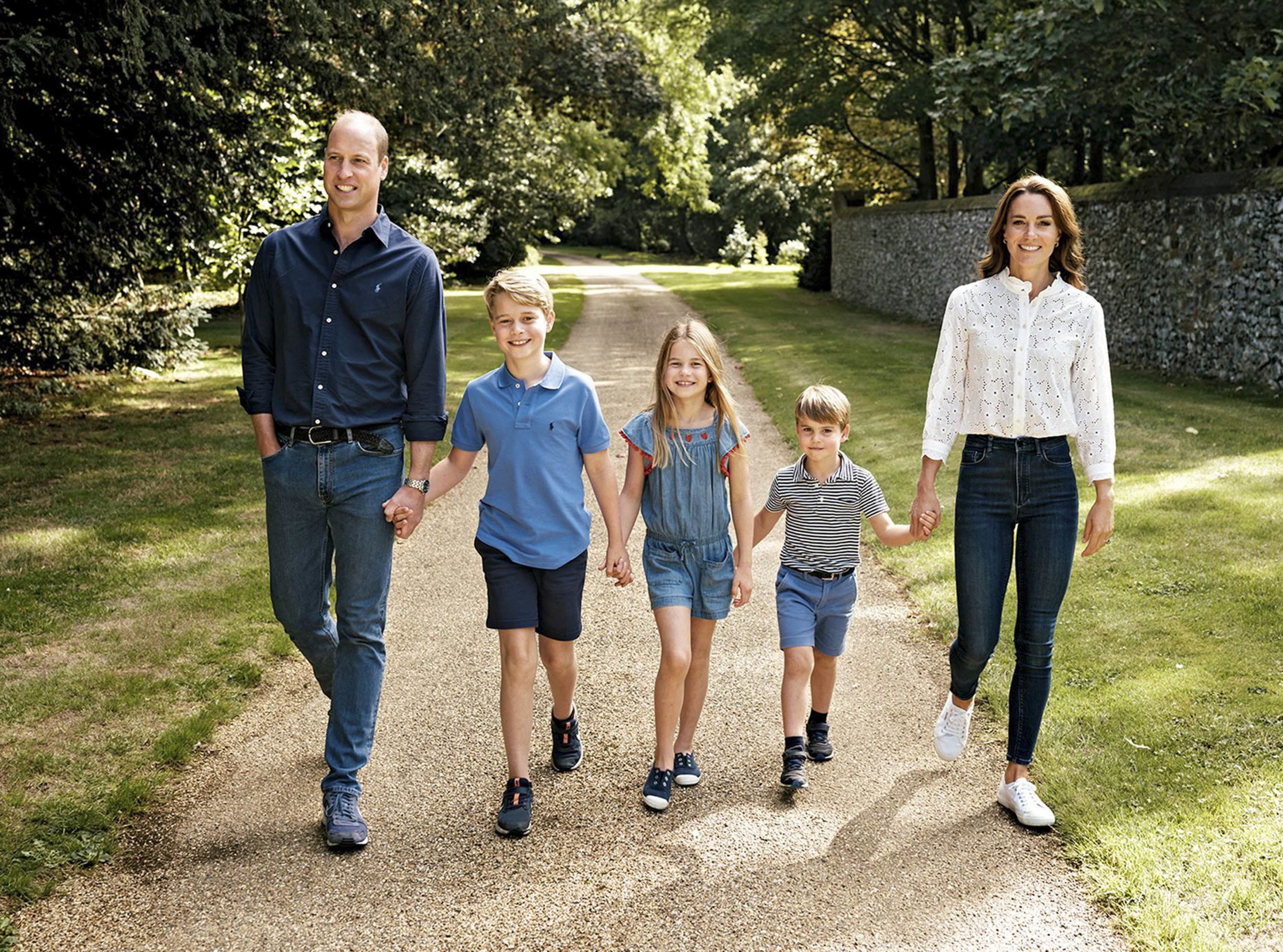 Britain's Prince William and his wife, Catherine, walk with their three children -- from left, George, Charlotte and Louis -- in Norfolk, England. The photo was featured on the family Christmas card in December 2022.