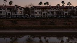 Palm trees and homes are reflected in the Central Arizona Project in Phoenix, Arizona, on April 6.