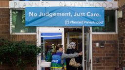 A clinic escort assists a patient at a Planned Parenthood Health Center in Philadelphia, Pennsylvania on September 28, 2022.