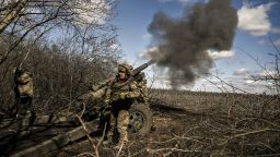 Ukrainian servicemen fire at Russian positions with a 105mm howitzer in the region of Donbas, on March 13, 2023, amid the Russian invasion of Ukraine.