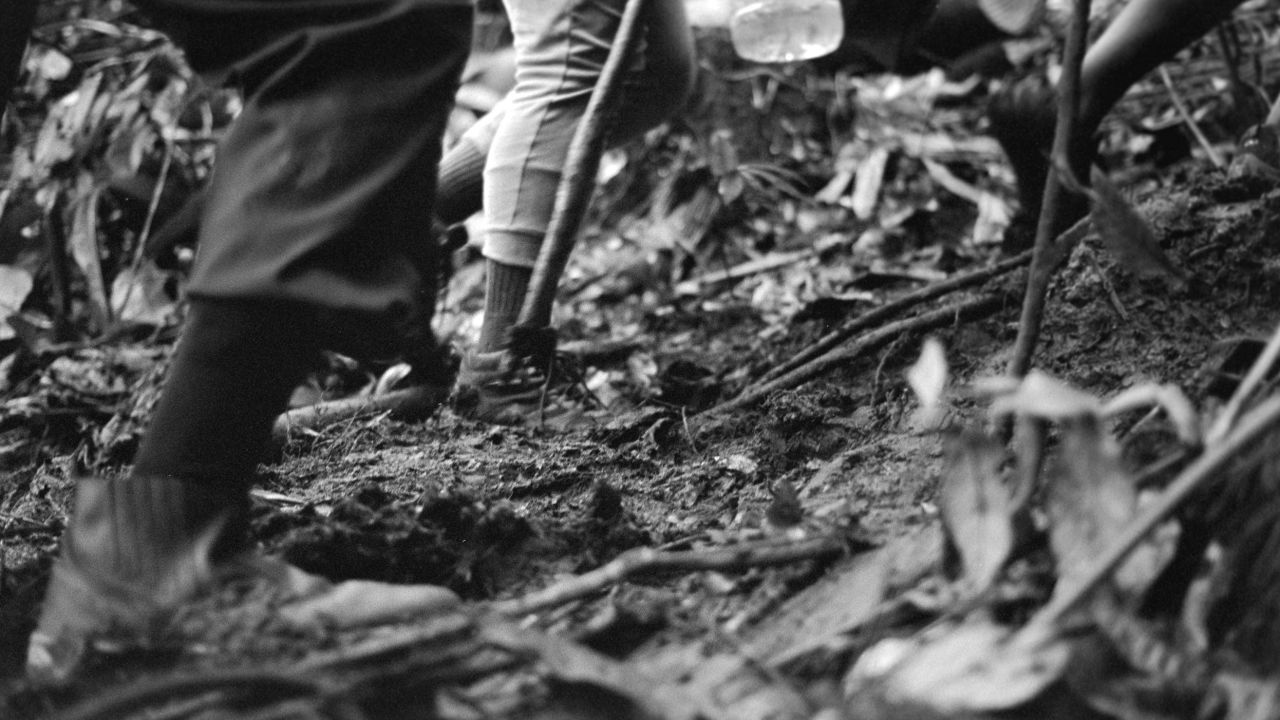 Most migrants are ill-equipped to hike the unforgiving terrain. It's dry season, yet the ground still sucks you in with every step.