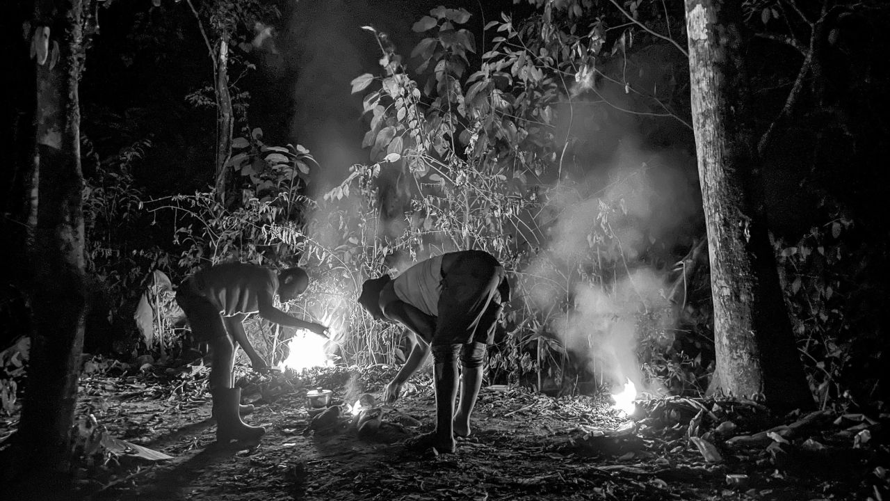 Stopping to camp overnight, people burn plastic to cook what they've carried with them. Many have fled countries where food and other basic goods are in short supply.