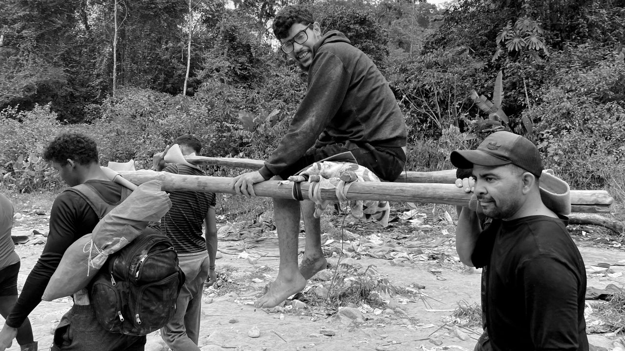 A Venezuelan man, who was injured and stuck on the route for days, is carried on a makeshift stretcher made by other migrants.