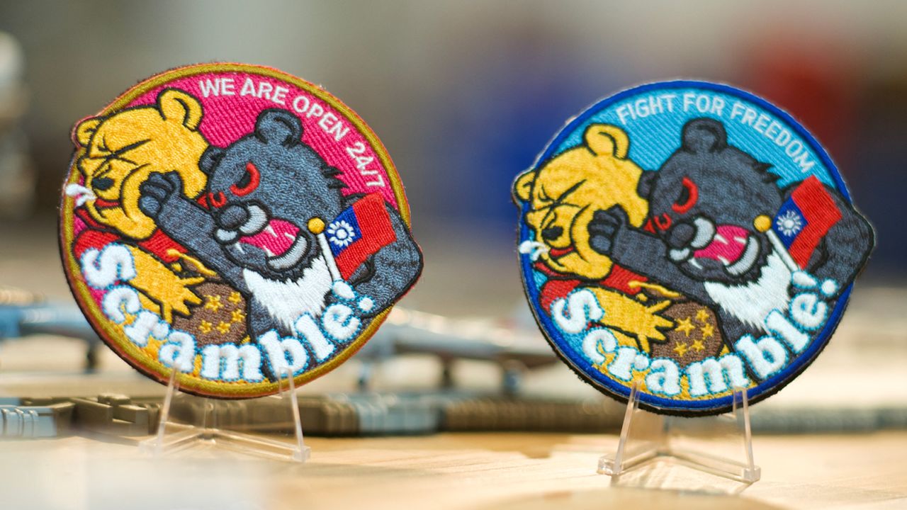 This picture shows patches depicting a Formosan black bear holding a Taiwanese flag punching Winnie-the-Pooh at a shop in Taoyuan on April 11, 2023. 