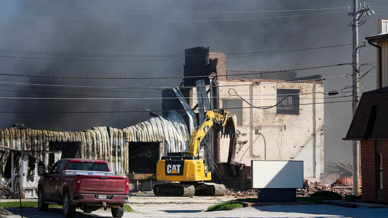Workers knock down part of the site of an industrial fire Wednesday in Richmond, Indiana.