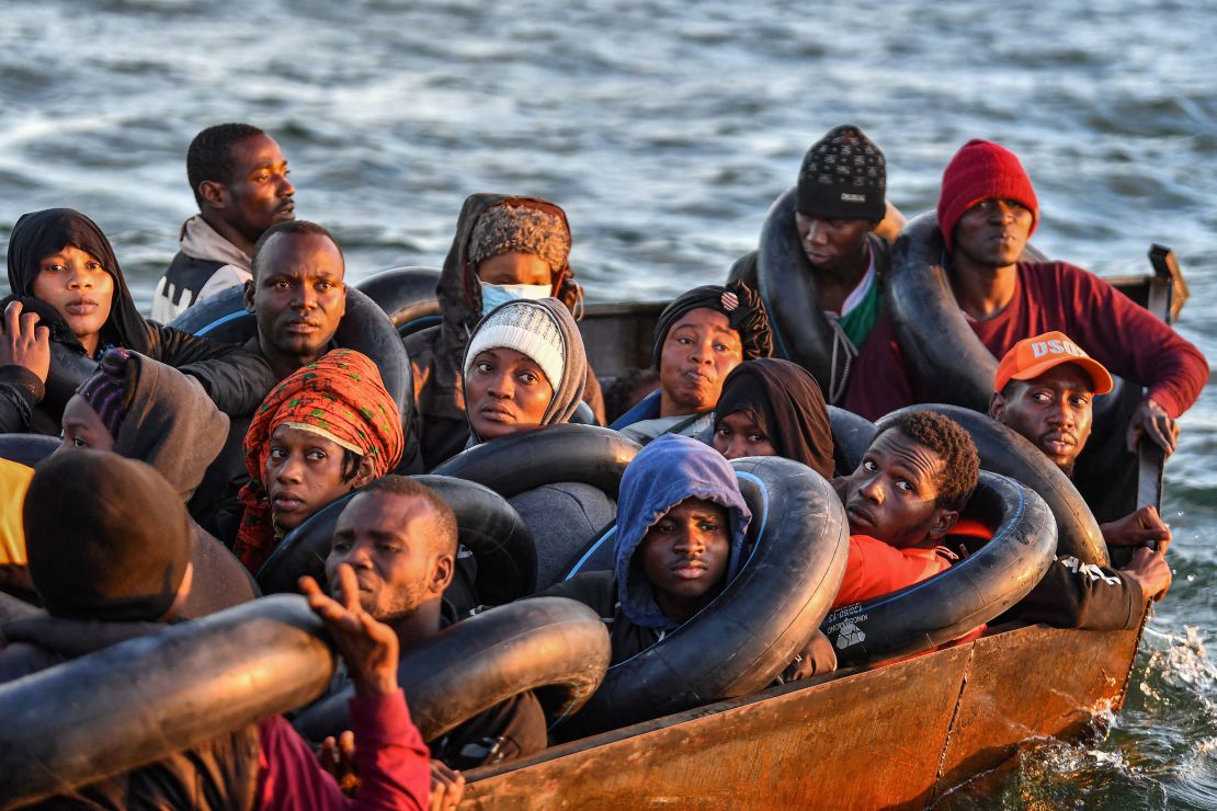 Migrants from sub-Saharan Africa, pictured on October 4, 2022, sit in a makeshift boat as they travel towards the Italian coast.