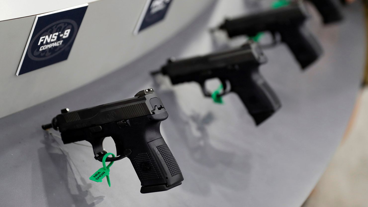 Guns are seen on display in trade booths during the National Rifle Association's annual meeting in Louisville, Kentucky, May 21, 2016.