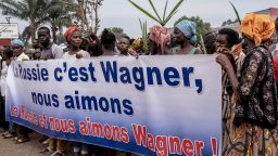 Demonstrators carry a banner in Bangui, on March 22, 2023 during a march in support of Russia and China's presence in the Central African Republic. - Central African Republic authorities have opened an investigation into the deaths of nine Chinese nationals killed in an attack on a gold mine in the centre of the country on March 19, 2023. Taking advantage of the vacuum created by the departure of the bulk of French troops, Moscow sent "military instructors" to the country in 2018, then hundreds of Wagner paramilitaries in 2020 at the request of Bangui, faced with a threatening rebellion. (Photo by Barbara DEBOUT / AFP) (Photo by BARBARA DEBOUT/AFP via Getty Images)