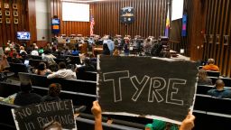 Audience members hold up signs stating "no justice in policing" and honoring Tyre Nichols during a Memphis City Council meeting on Tuesday, April 11, 2023. Two items on the agenda were police reform ordinances. The "Achieving Driving Equality" ordinance passed while the other, which had opposition from advocates and questions from council members as to whether it was redundant, was tabled indefinitely.