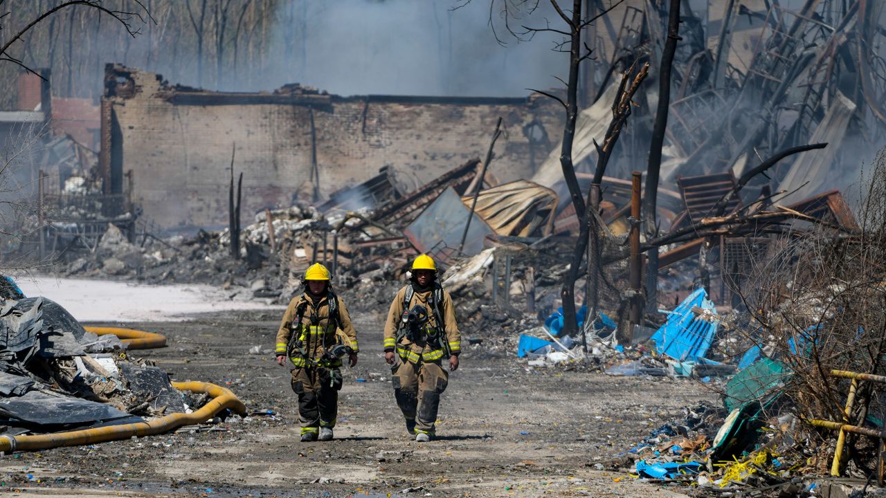 Firefighters walk out of the fire site Wednesday in Richmond, Indiana.
