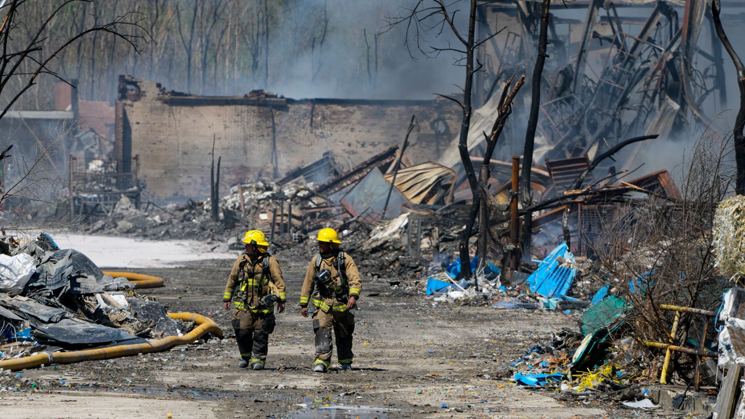 Firefighters walk out of the site of the recycling plant fire in Richmond, Indiana, on Wednesday.