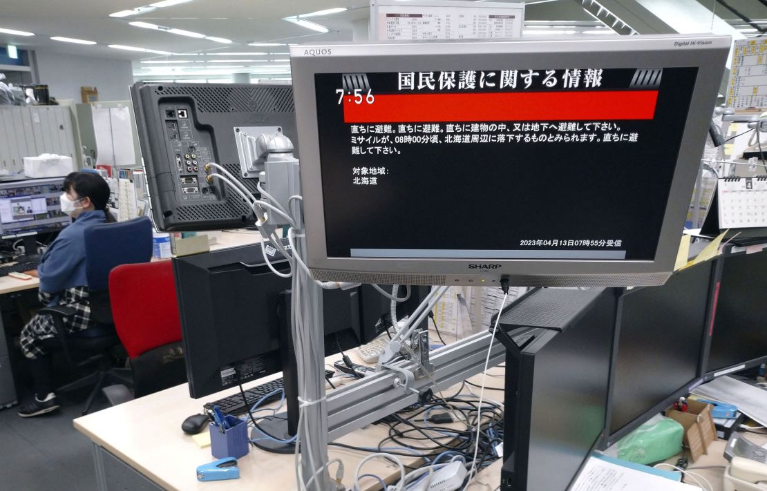 A screen in a Tokyo office on Thursday morning shows a Japanese government statement warning citizens of the northernmost main island of Hokkaido to take immediate cover and stay inside buildings, saying a missile was likely to fall near the island.
