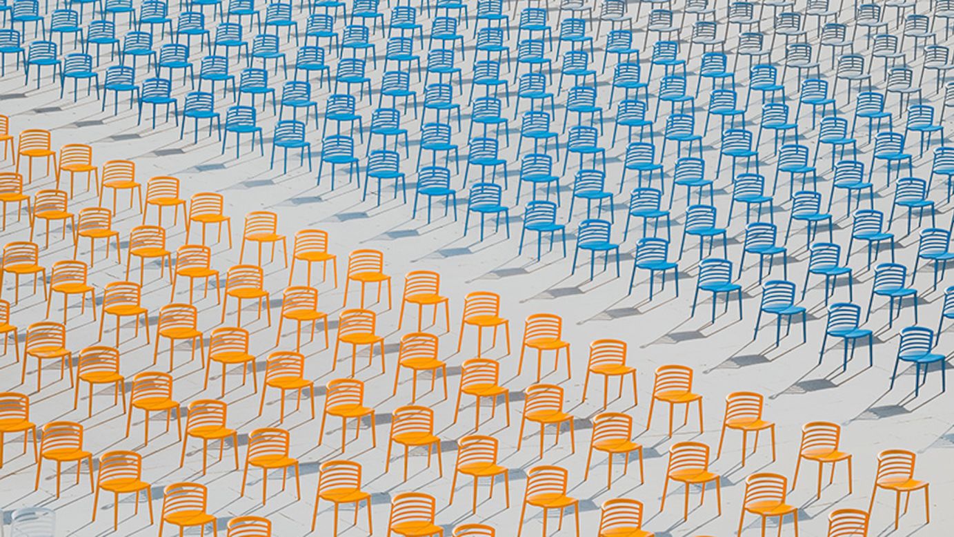 Youth Photographer of the Year went to 17-year-old Hai Wang for his photograph showing endless rows of empty colored chairs after a school ceremony was canceled during the Covid-19 pandemic. 