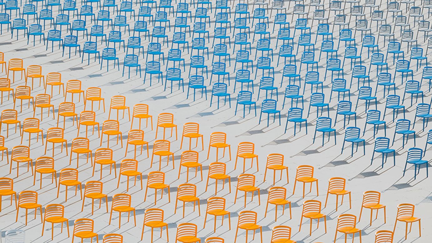 Youth Photographer of the Year went to 17-year-old Hai Wang for his photograph showing endless rows of empty colored chairs after a school ceremony was canceled during the Covid-19 pandemic.