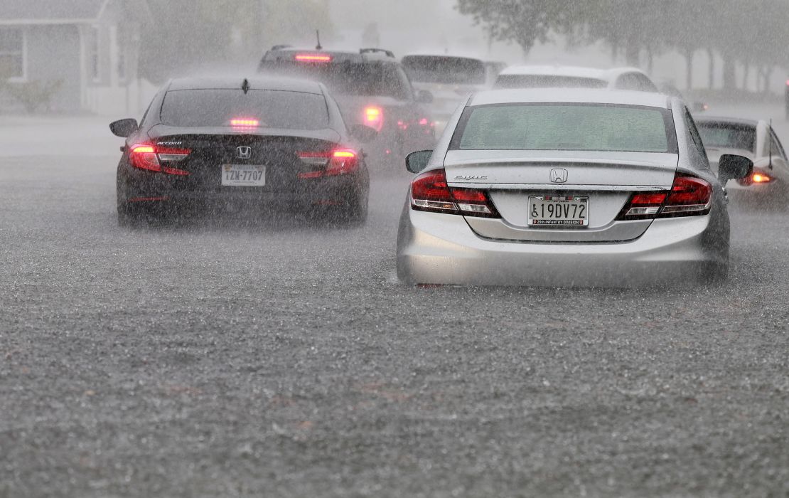 Cars are parked in a flooded street Wednesday in Dania Beach, Florida. 